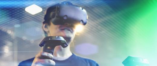 young man use virtual reality goggles or vr headset or helmet play videogame with wireless controller